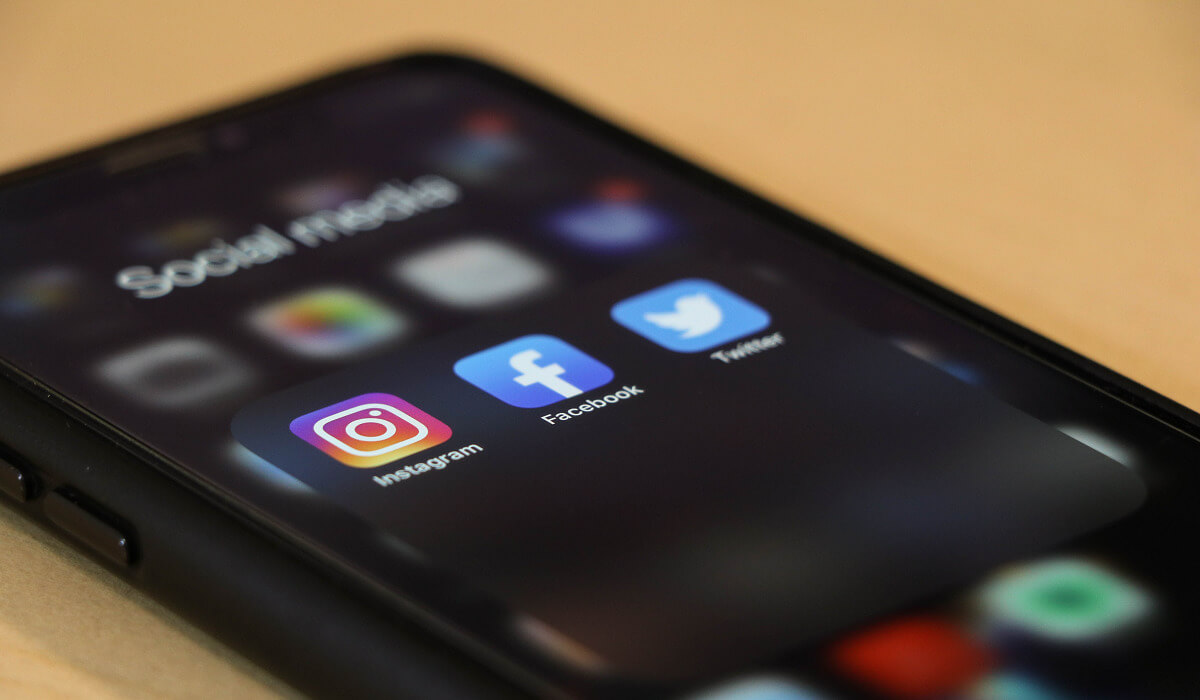 A smartphone with social media icons on it.