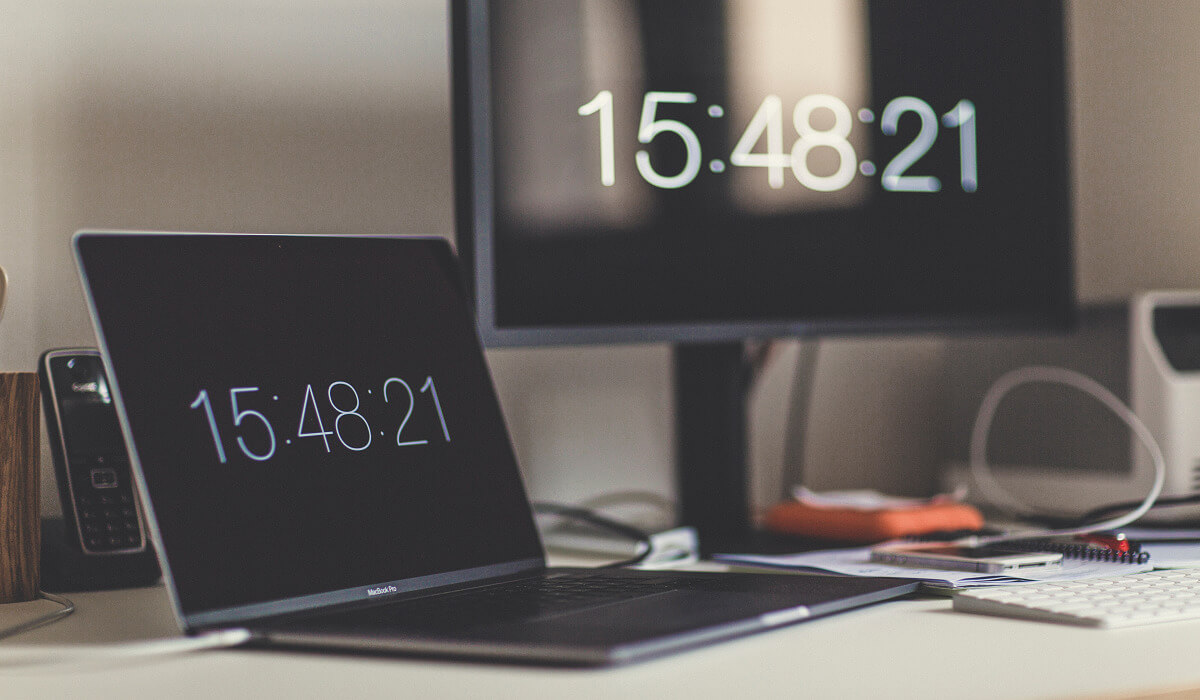Two computers showing the time.