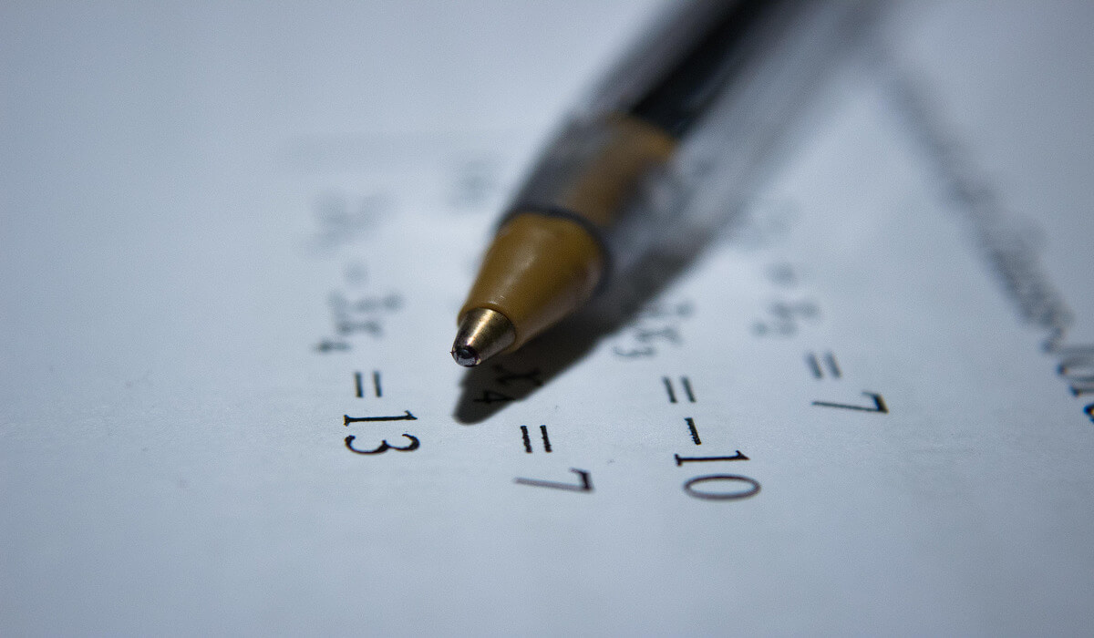 A pen writing an equation.
